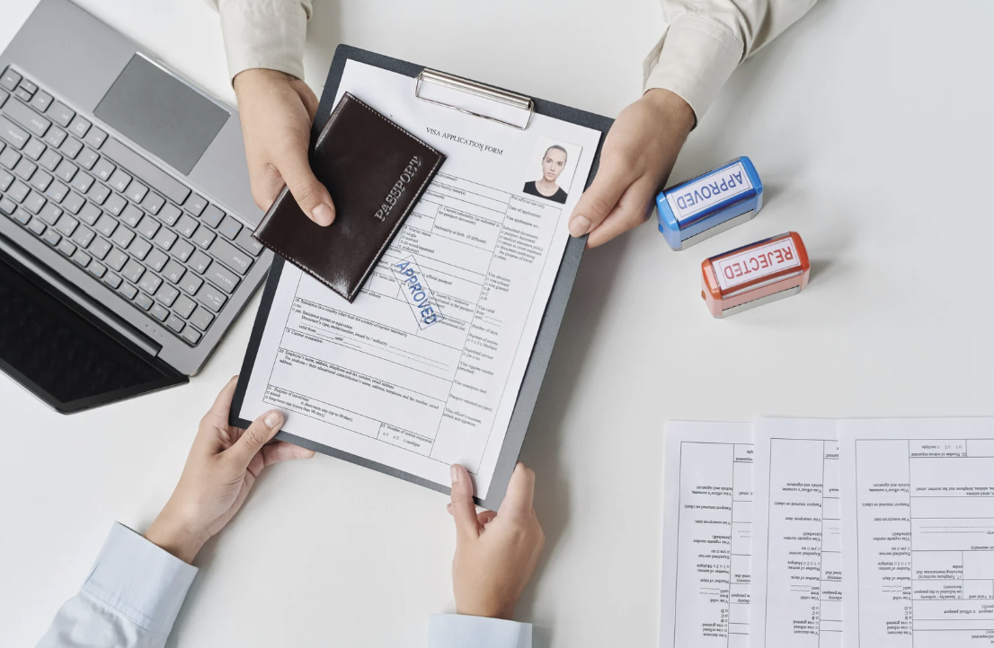 Visa application form being reviewed and approved with a passport